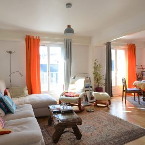 Séjour sur parquet vue vers balcon carré site